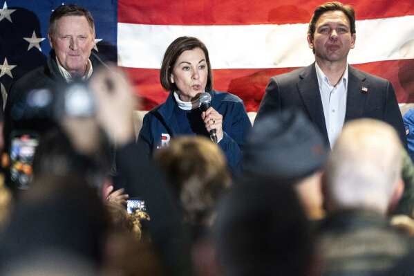 Iowa Gov. Kim Reynolds speaks as Florida Gov. Ron Desantis, right, campaigns for president on Saturday, Jan. 13, 2024, at the Never Back Down Campaign Headquarters in West Des Moines, Iowa. (Lily Smith/The Des Moines Register via AP)